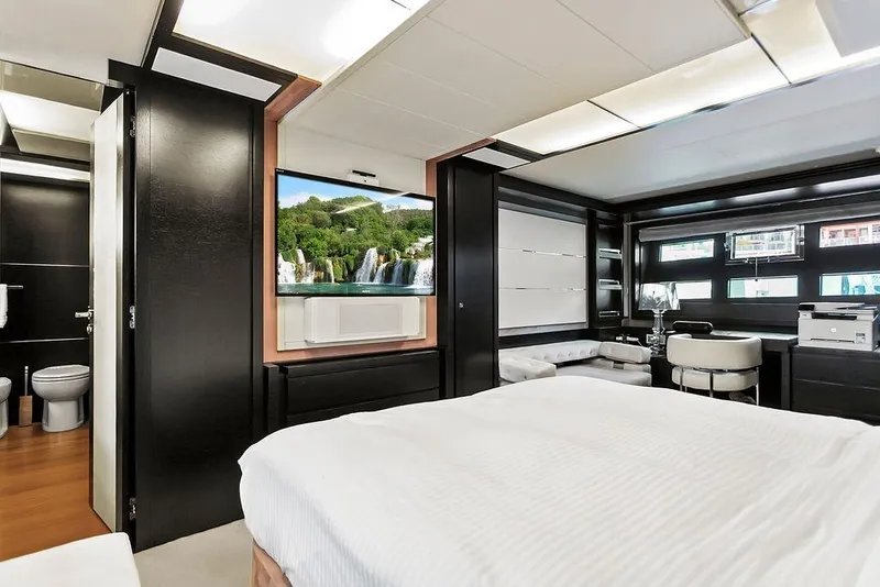 Slide: The Image of Luxurious 2011 Baia yacht interior with modern bedroom, TV, and elegant furnishings. - 54