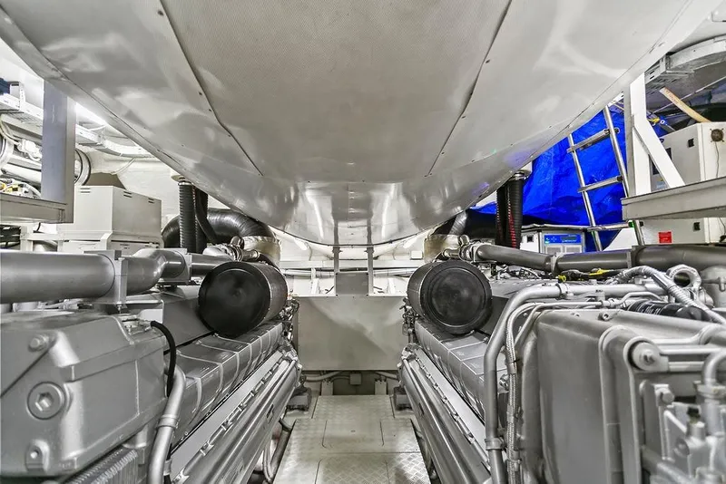 Slide: The Image of Engine room of a 2011 Baia yacht, showcasing dual engines and mechanical components. - 58