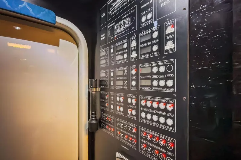 Slide: The Image of Control panel inside a 2011 Baia model xxx yacht, featuring various switches and indicators. - 65