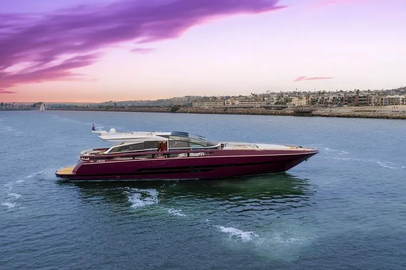 Slide: The Image of Luxurious 2011 Baia xxx yacht cruising at sunset with vibrant sky and coastal backdrop. - 7