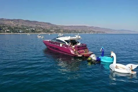 Slide: The Image of Luxury 2011 Baia ONE HUNDRED yacht on serene water with inflatable swans nearby. - 70