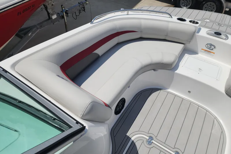 Slide: The Image of 2023 Hurricane SunDeck 187 OB boat interior with white and red seating, cup holders, and deck. - 14