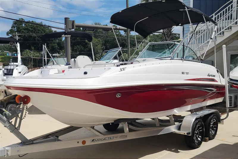 Slide: The Image of 2023 Hurricane SunDeck 187 OB boat with red and white design on a trailer. - 3