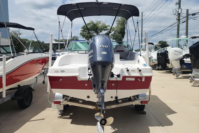 Slide: The Image of 2023 Hurricane SunDeck 187 OB boat with Yamaha 150 engine, displayed outdoors. - 5