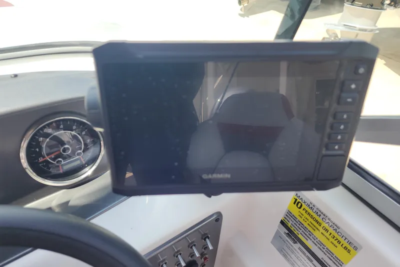 Slide: The Image of Dashboard of 2023 Hurricane SunDeck 187 OB with Garmin display and capacity label. - 8