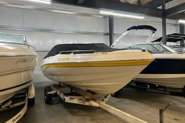 The Image of 2003 Chaparral 210 SS boat on trailer in indoor storage facility. - 1