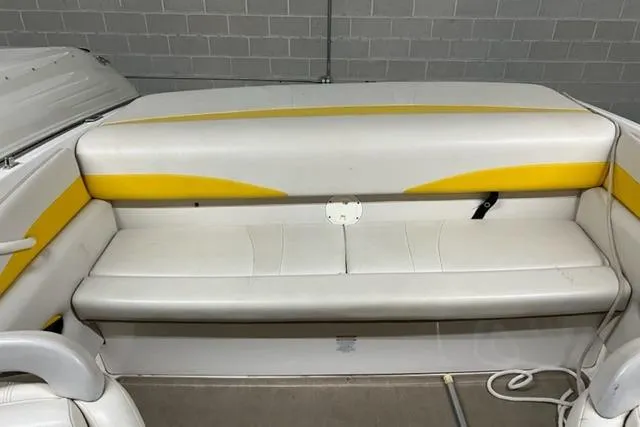 Slide: The Image of 2003 Chaparral 210 SS boat interior with white and yellow seating. - 3