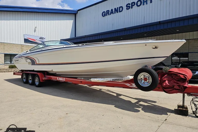 Slide: The Image of 2005 Formula 353 FASTech boat on red trailer outside Grand Sport building. - 11