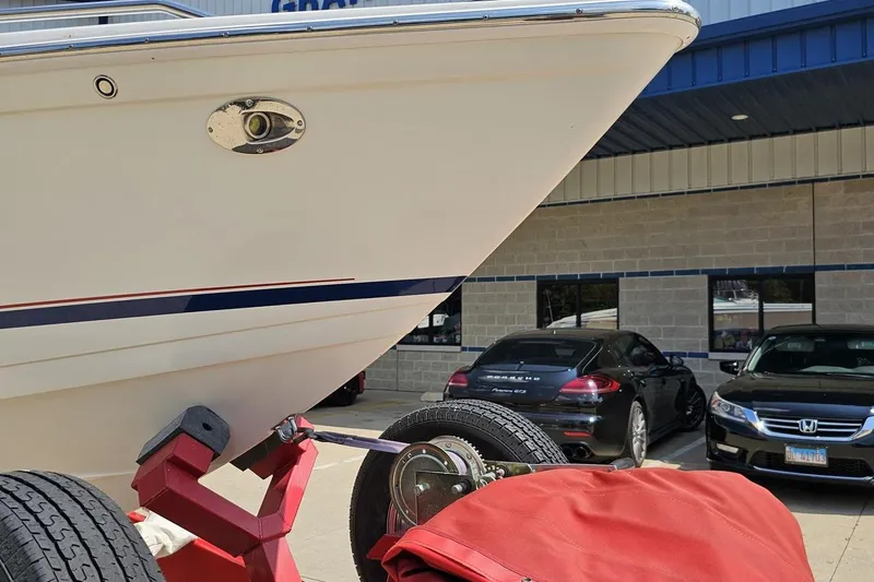 Slide: The Image of 2005 Formula 353 FASTech boat on trailer, parked near cars outside a building. - 12