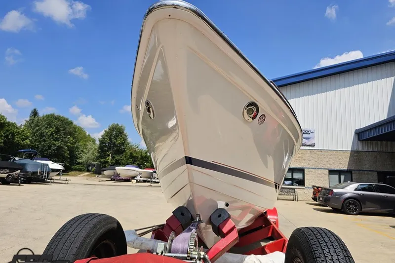 Slide: The Image of 2005 Formula 353 FASTech boat on trailer, parked outdoors near a building. - 13