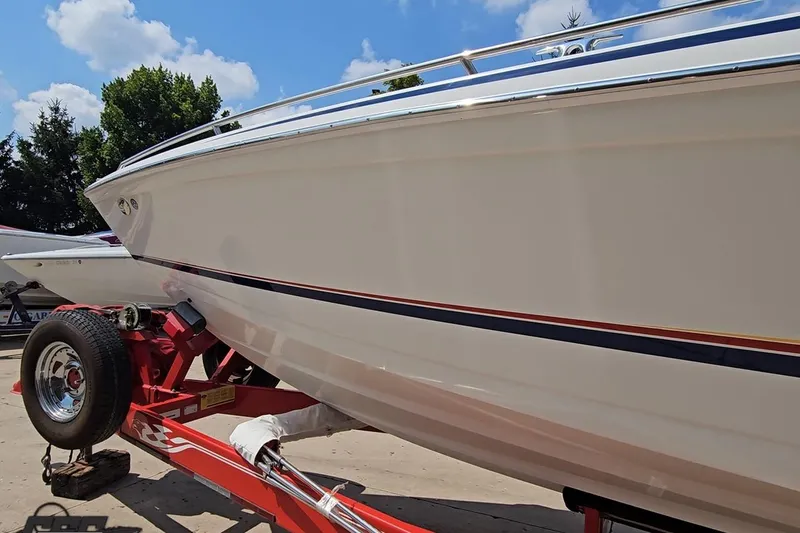 Slide: The Image of 2005 Formula 353 FASTech boat on red trailer under blue sky. - 15