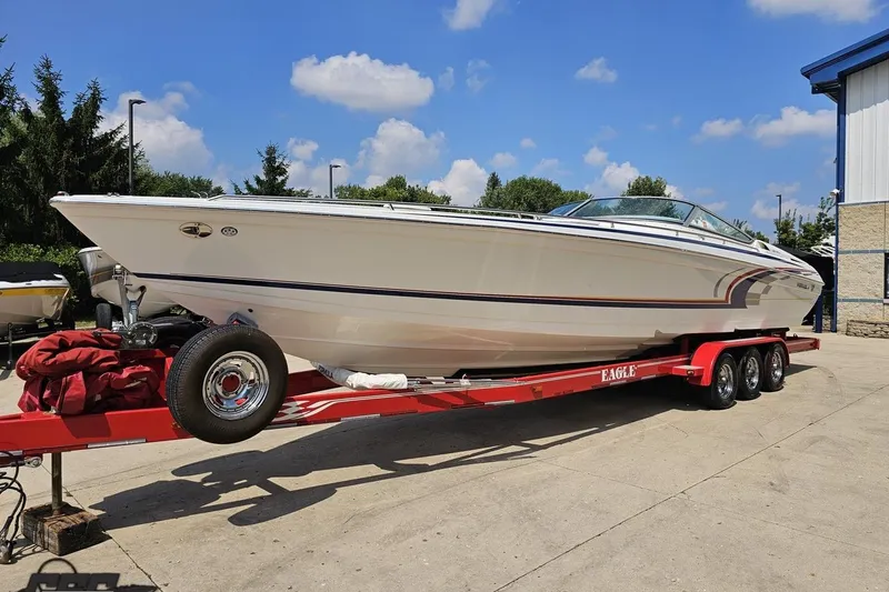 Slide: The Image of 2005 Formula 353 FASTech boat on red trailer under blue sky. - 16