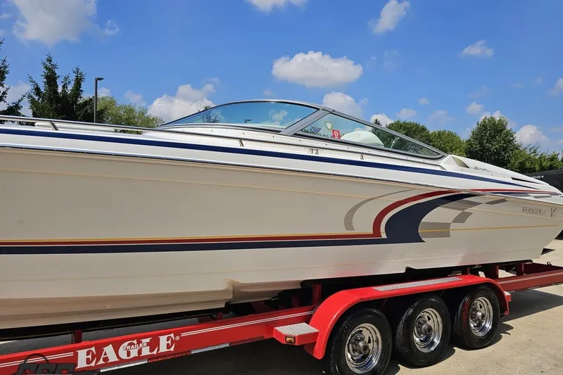 Slide: The Image of 2005 Formula 353 FASTech boat on red trailer under blue sky. - 19