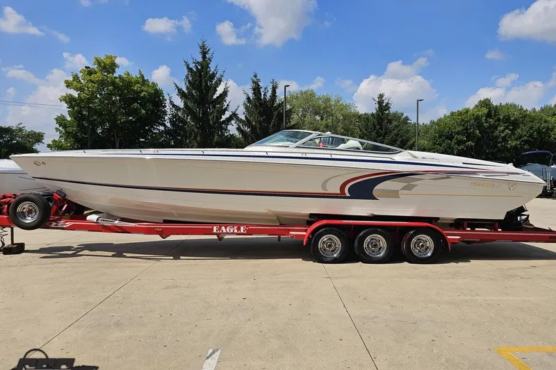 Slide: The Image of 2005 Formula 353 FASTech boat on red trailer, parked outdoors under blue sky. - 23