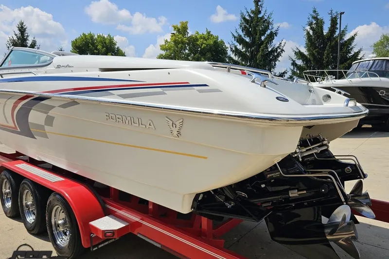 Slide: The Image of 2005 Formula 353 FASTech boat on red trailer, sleek design, vibrant graphics. - 26