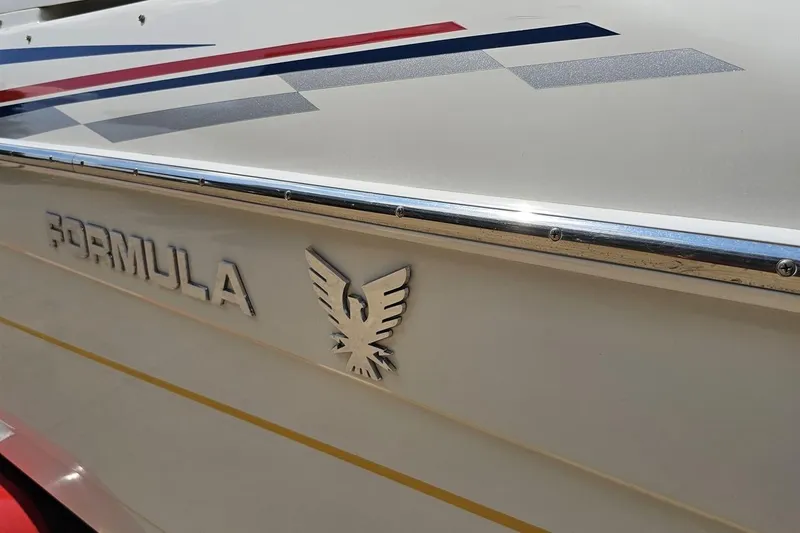 Slide: The Image of 2005 Formula 353 FASTech boat with sleek design and vibrant graphics. - 27