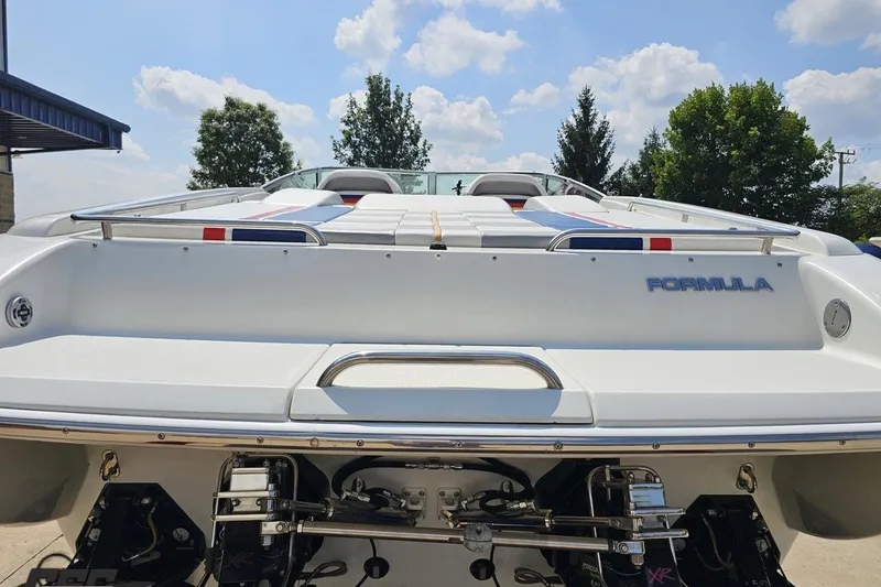 Slide: The Image of 2005 Formula 353 FASTech boat, rear view, showcasing sleek design and powerful engines. - 32