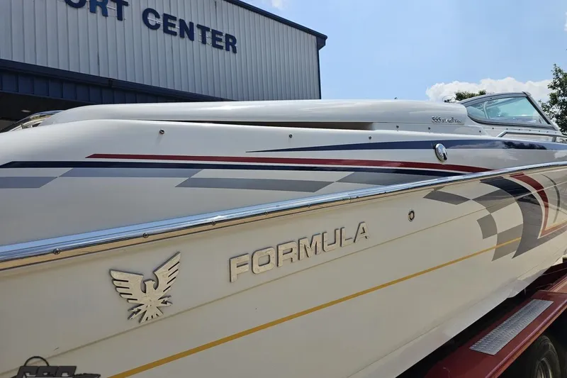 Slide: The Image of 2005 Formula 353 FASTech boat with sleek design, parked near a sport center. - 36