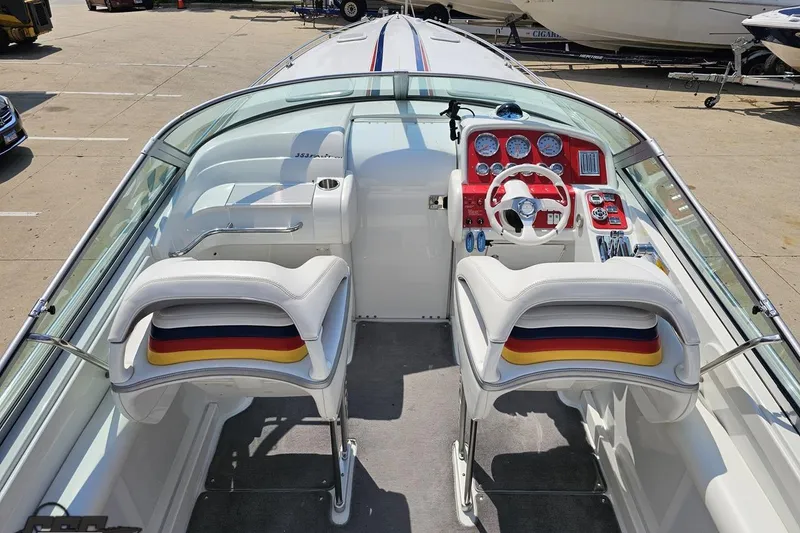 Slide: The Image of 2005 Formula 353 FASTech boat cockpit with white seats and red dashboard. - 47