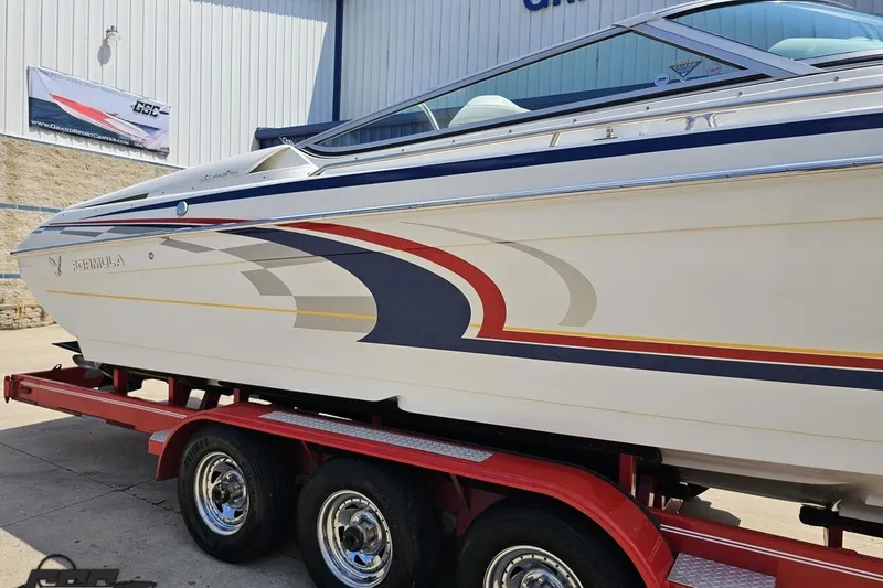 Slide: The Image of 2005 Formula 353 FASTech boat on red trailer, side view with colorful graphics. - 5