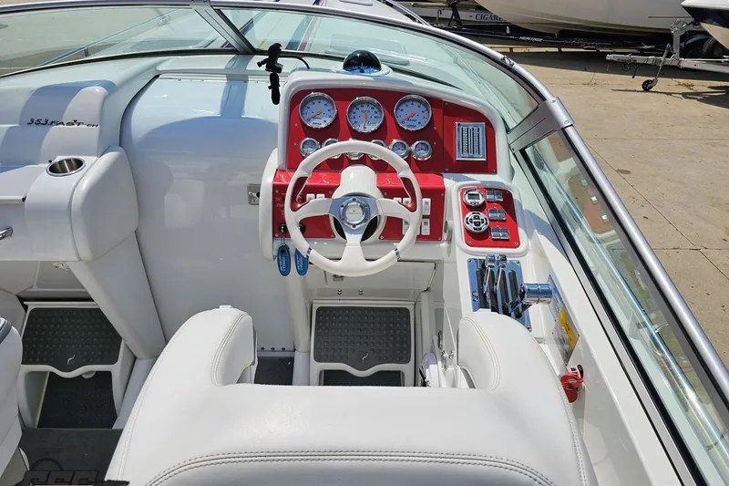 Slide: The Image of 2005 Formula 353 FASTech boat cockpit with red dashboard and white steering wheel. - 53