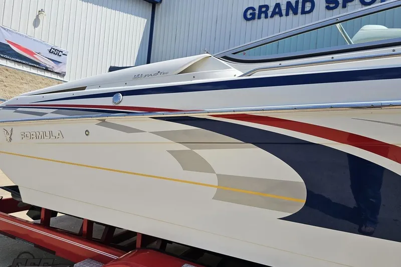 Slide: The Image of 2005 Formula 353 FASTech boat with sleek design and vibrant graphics at Grand Sport Center. - 6