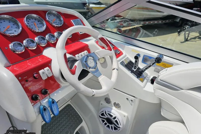 Slide: The Image of 2005 Formula 353 FASTech boat cockpit with red dashboard and white steering wheel. - 62