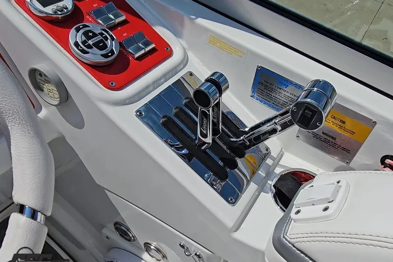 Slide: The Image of 2005 Formula 353 FASTech boat controls with chrome levers and red panel accents. - 66