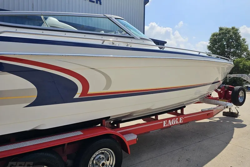 Slide: The Image of 2005 Formula 353 FASTech boat on red trailer, featuring sleek design and vibrant graphics. - 7