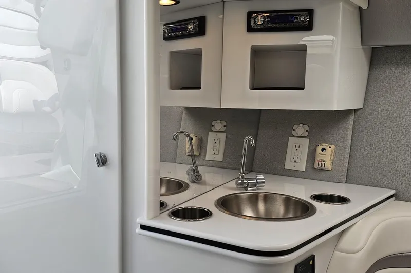 Slide: The Image of Interior of a 2005 Formula 353 FASTech boat featuring a compact kitchenette with sink and storage. - 76