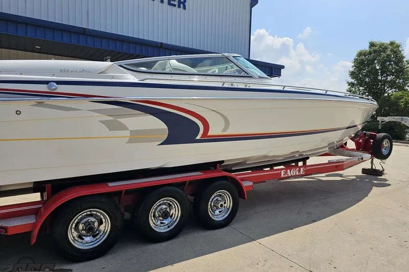 Slide: The Image of 2005 Formula 353 FASTech boat on red trailer, parked outdoors under blue sky. - 8