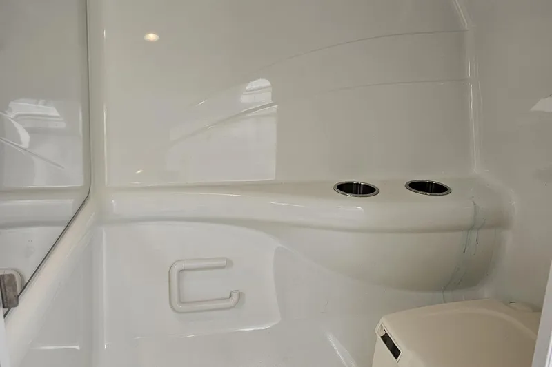 Slide: The Image of Interior of 2005 Formula 353 FASTech boat, featuring sleek white design and cup holders. - 83