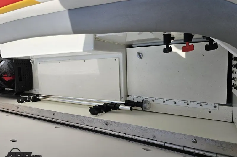 Slide: The Image of Storage compartment of a 2005 Formula 353 FASTech boat, featuring organized equipment and controls. - 92