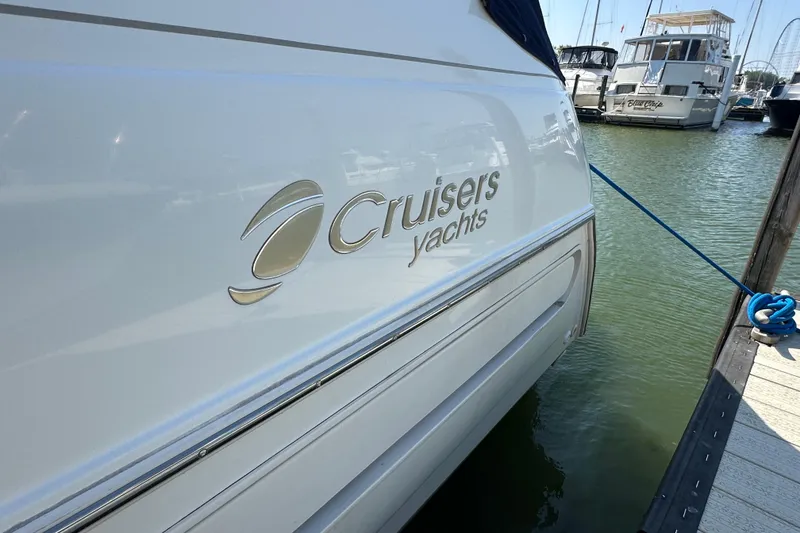 Slide: The Image of 1995 Cruisers Yachts 3570 Esprit docked, showcasing sleek design and branding. - 8