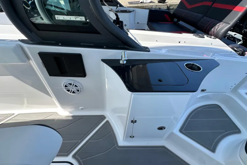 Slide: The Image of 2026 Monterey Elite 25 OB boat interior with sink, cup holder, and seating area. - 11