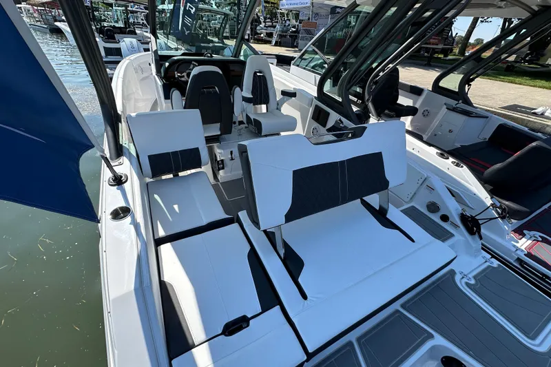 Slide: The Image of 2026 Monterey Elite 25 OB boat interior with white seating and modern design. - 8