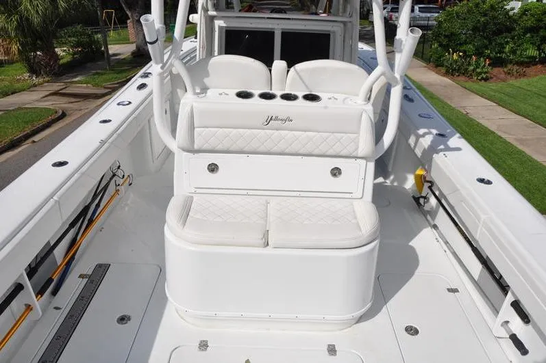 Slide: The Image of 2020 Yellowfin 32 Offshore boat interior with white seating and rod holders. - 13
