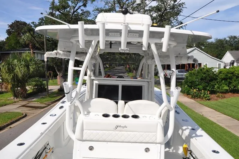 Slide: The Image of 2020 Yellowfin 32 Offshore boat with white seating and fishing rod holders. - 14