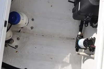 Slide: The Image of 2020 Yellowfin 32 Offshore boat interior with visible equipment and storage area. - 18