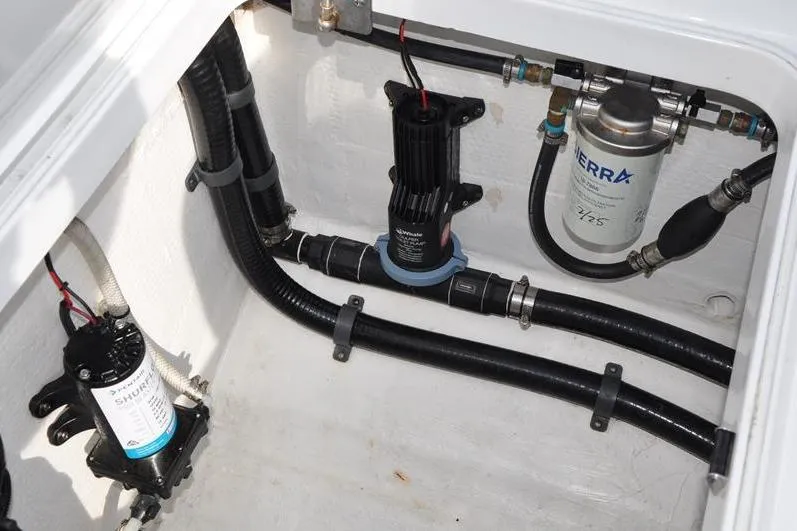 Slide: The Image of 2020 Yellowfin 32 Offshore boat engine compartment with pumps and filters. - 20
