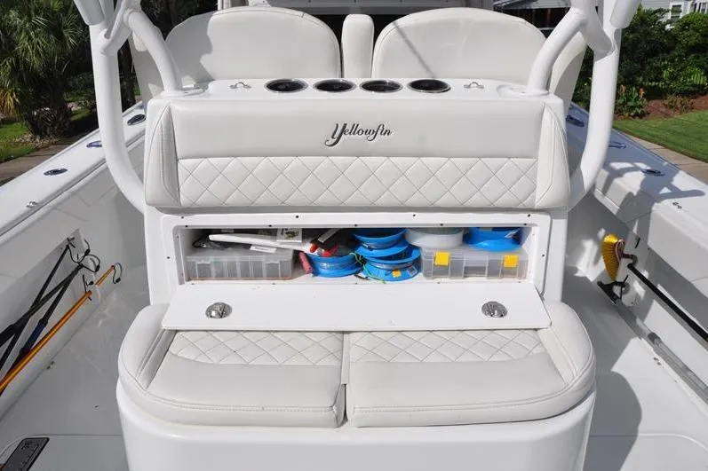 Slide: The Image of 2020 Yellowfin 32 Offshore boat with open storage compartment and fishing gear. - 24