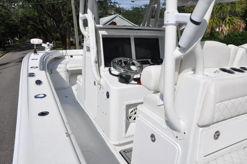 Slide: The Image of 2020 Yellowfin 32 Offshore boat interior with steering console and seating. - 25