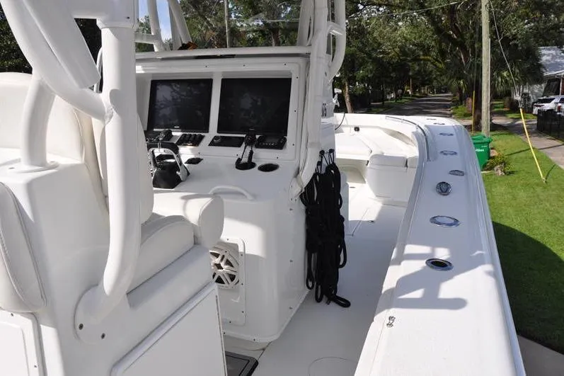 Slide: The Image of 2020 Yellowfin 32 Offshore boat interior with dual screens and seating. - 26