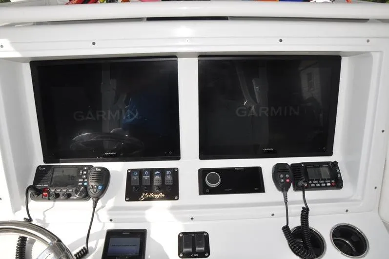 Slide: The Image of Dashboard of 2020 Yellowfin 32 Offshore boat with Garmin displays and communication devices. - 27