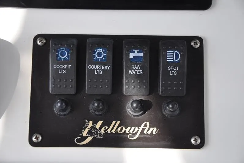 Slide: The Image of Control panel of a 2020 Yellowfin 32 Offshore boat with labeled switches. - 32