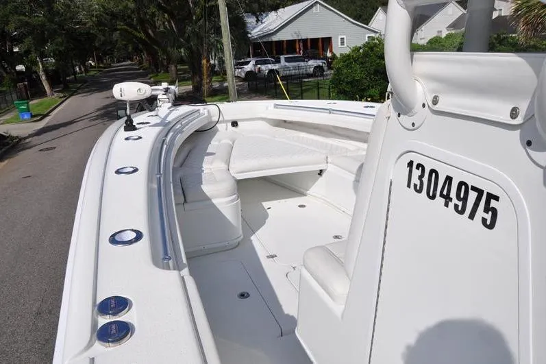Slide: The Image of 2020 Yellowfin 32 Offshore boat parked on a residential street, showcasing its spacious deck. - 35