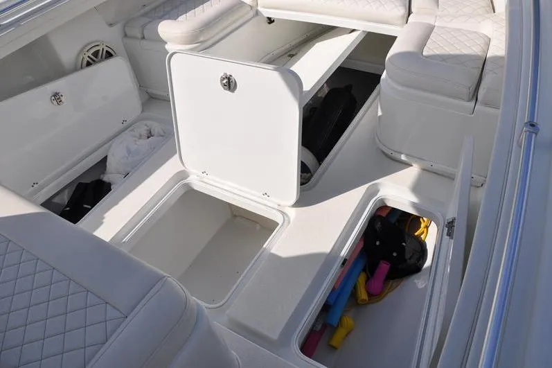 Slide: The Image of 2020 Yellowfin 32 Offshore boat interior with open storage compartments and cushioned seating. - 40