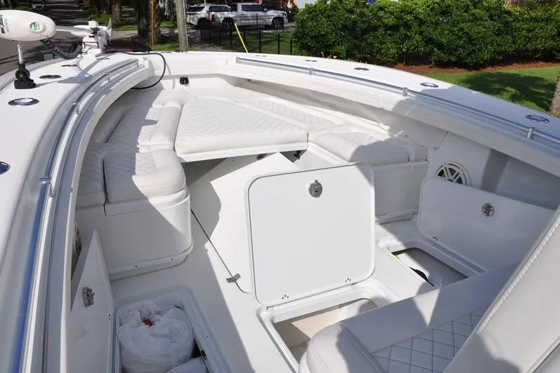 Slide: The Image of 2020 Yellowfin 32 Offshore boat interior with white seating and storage compartments. - 41