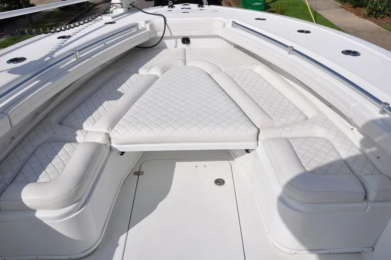 Slide: The Image of 2020 Yellowfin 32 Offshore boat with white cushioned seating and sleek design. - 42