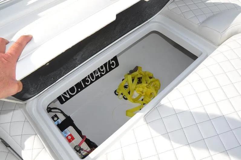 Slide: The Image of Open storage compartment on 2020 Yellowfin 32 Offshore boat with yellow straps inside. - 45